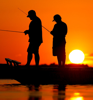 men on boat at sunset